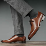 Menβs formal tan leather wholecut Oxford shoes with polished finish