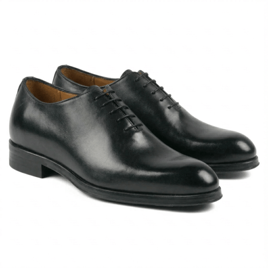 A pair of elegant black leather wholecut Oxford shoes featuring a seamless design, handcrafted from premium calf leather with a polished finish and classic lacing.