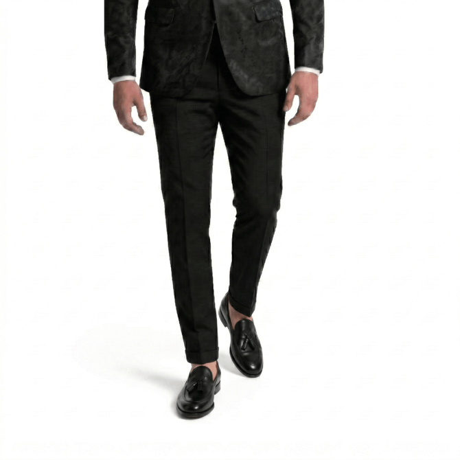 Front view of a man walking in premium black leather tassel loafers and slim-fit formal trousers, paired with a textured black floral blazer on a white background.