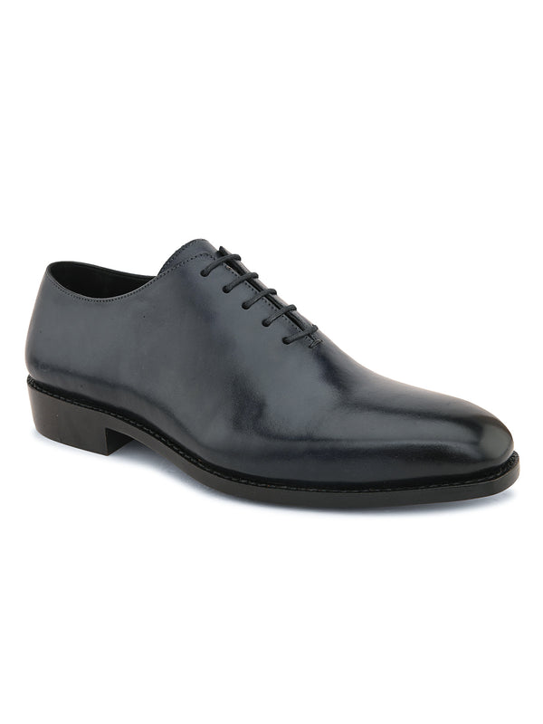 Men’s black wholecut leather Oxford shoes showcasing clean silhouette, smooth finish and lace-up style