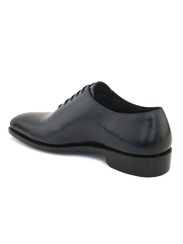 Black whole cut leather formal Oxford shoes with minimal stitching and refined craftsmanship