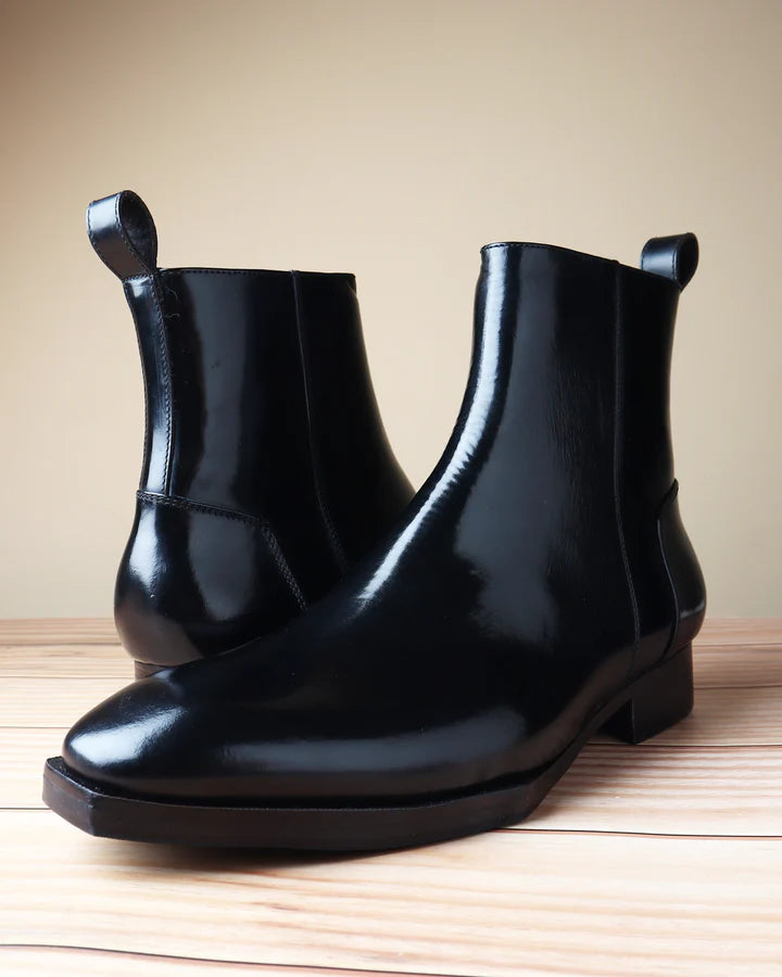 Menβs black brushed leather zip boots with spade sole and sleek side profile