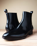 Menβs black brushed leather zip boots with spade sole and sleek side profile