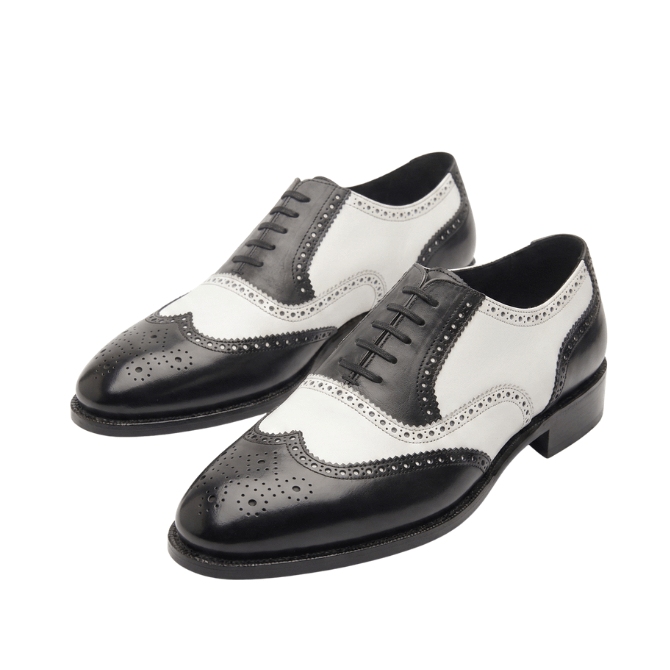 Pair of black and white leather wingtip brogue shoes for men