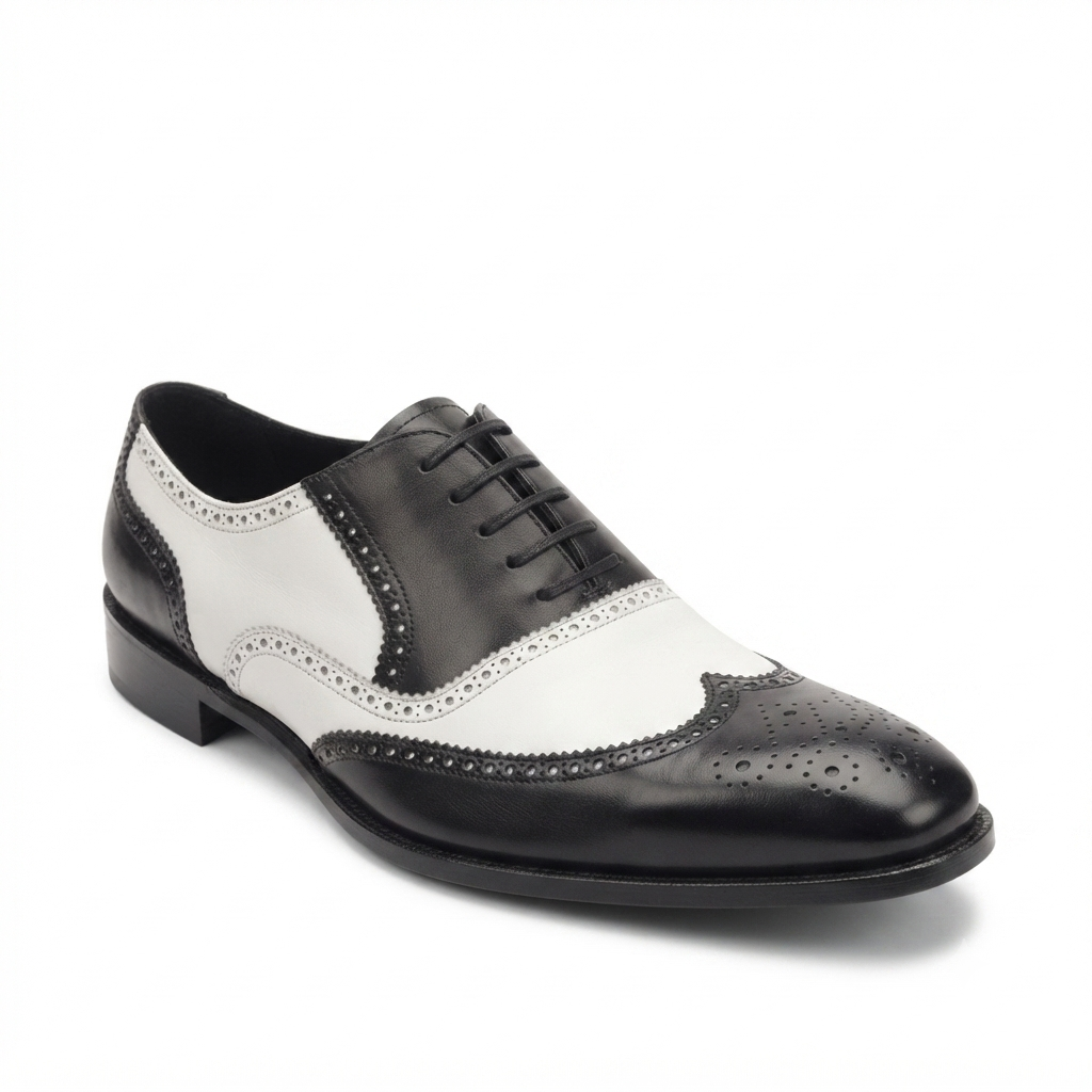 Side profile of black and white leather wingtip brogue shoe