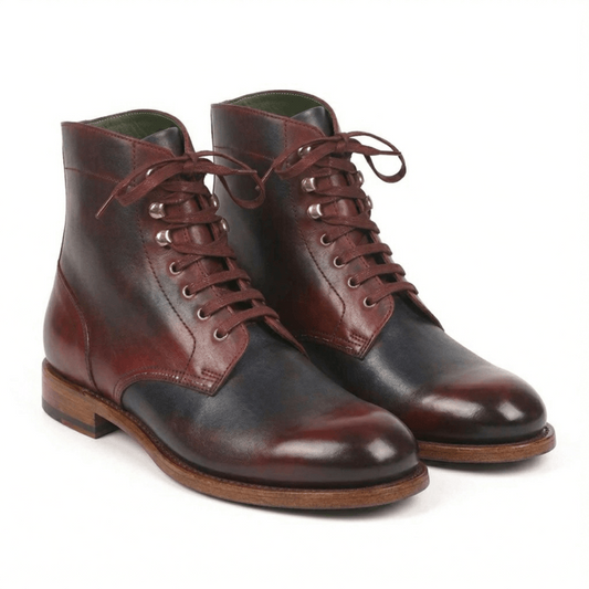 A pair of premium handcrafted leather lace-up boots featuring a sophisticated two-tone patina in burgundy and dark navy, with silver-toned speed hooks and a durable Goodyear-welted leather sole.