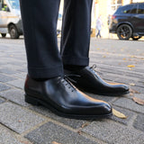 Side profile of black wholecut Oxford shoes for men with refined silhouette