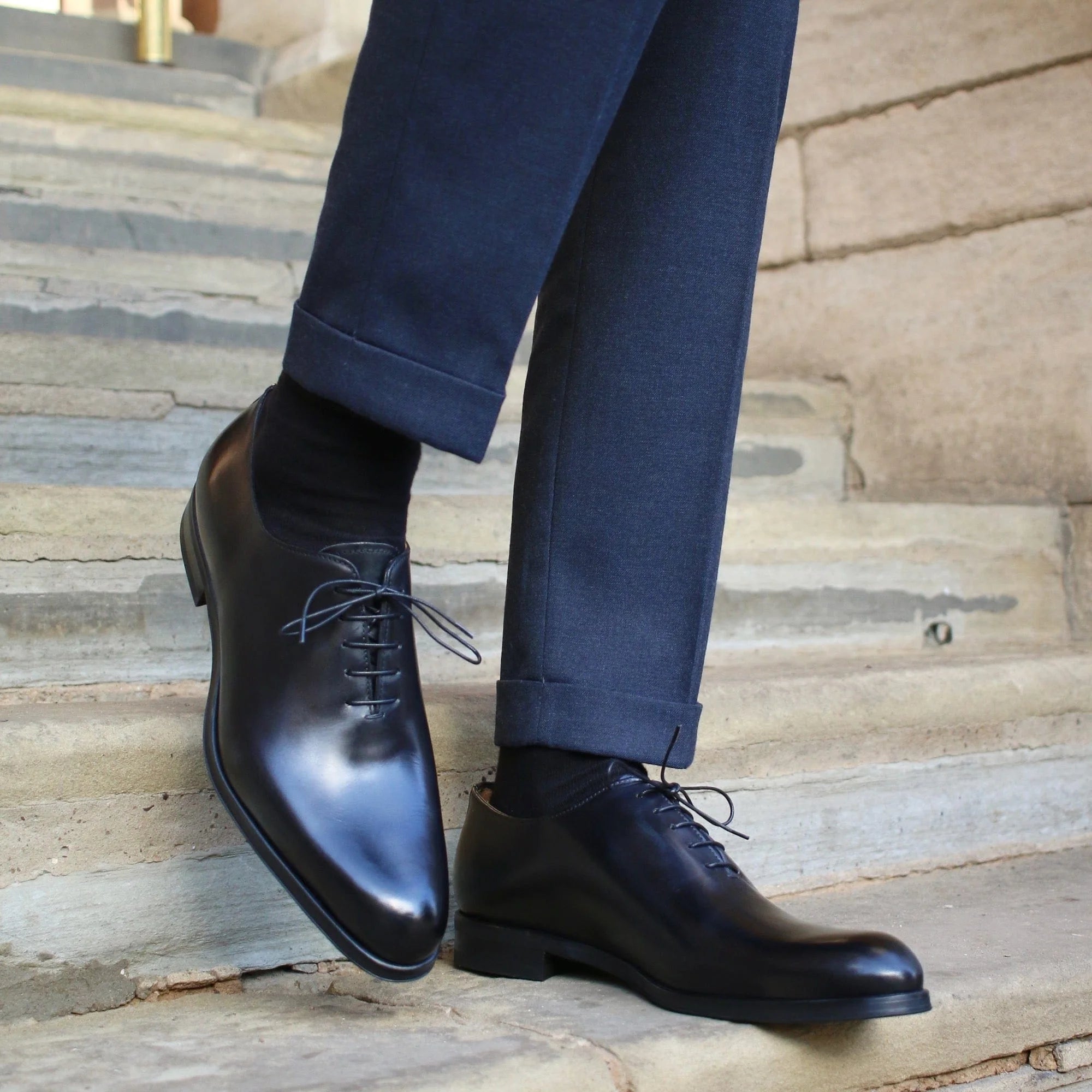 Menβs black wholecut Oxford shoes showing clean stitching and smooth leather finish