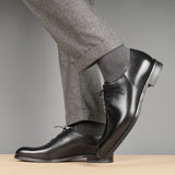 Side profile of black wholecut Oxford shoes for men with refined silhouette
