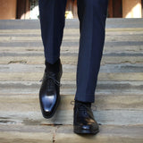 Handcrafted menβs black leather wholecut Oxford shoes with sleek design