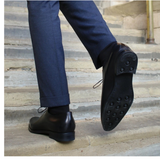 Handcrafted menβs black leather wholecut Oxford shoes with sleek design