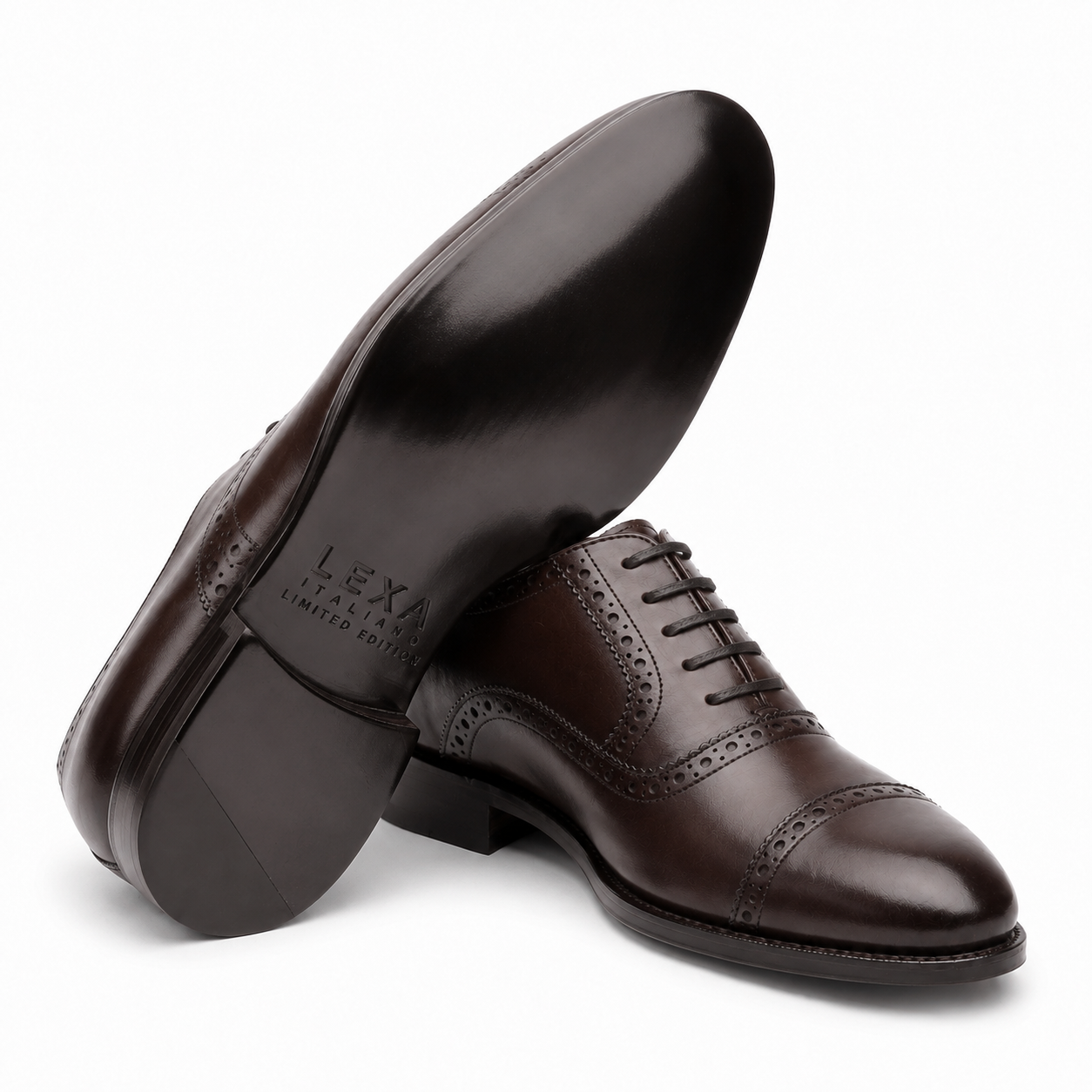 Dark brown leather Oxford shoes arranged in a crossed position showing the leather upper