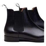 Black leather men Chelsea boots showing pull tab and ankle fit