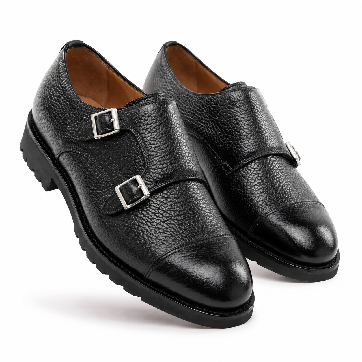 Angled view of black leather double monk strap shoes