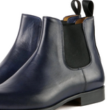 Close-up view of men’s Chelsea boots showing premium leather texture and stitching