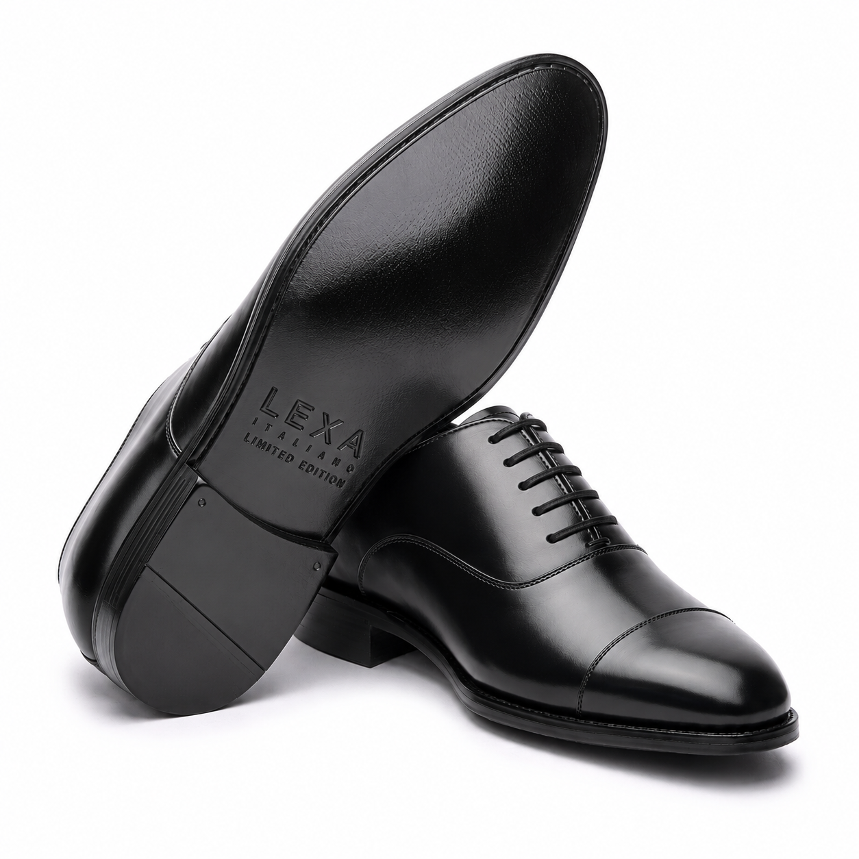Black leather Oxford shoes arranged in a crossed position showing the polished upper