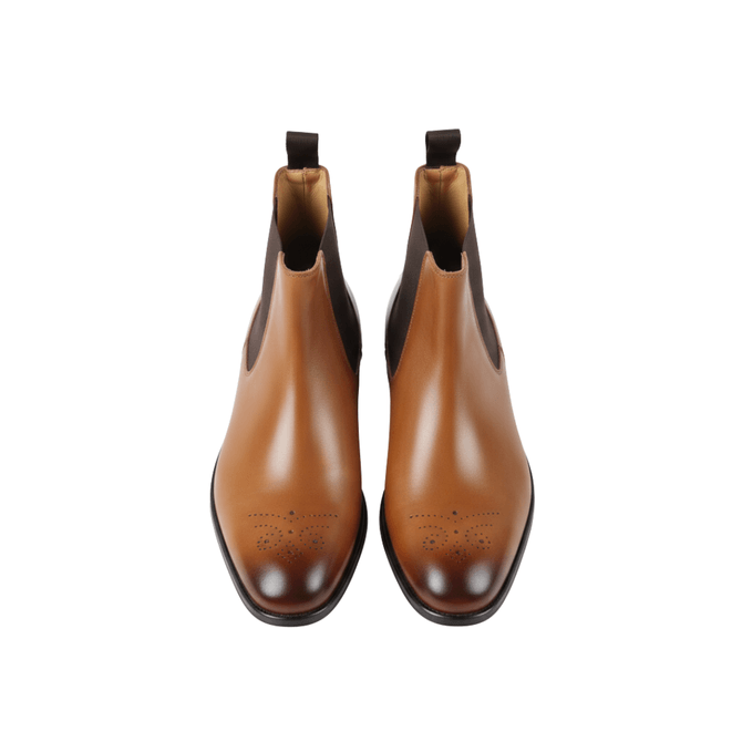 Brown leather Chelsea boots toe detail with brogue perforation front view