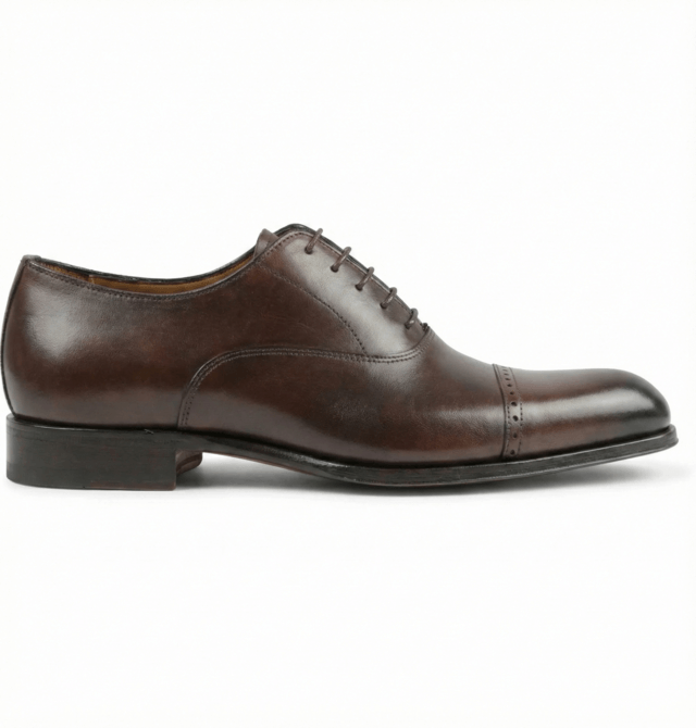 Side profile of dark brown wholecut oxford shoe clean formal silhouette
