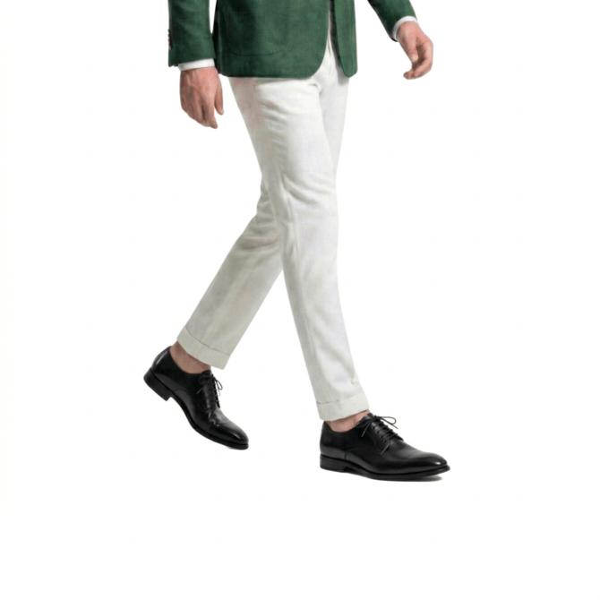 Side styling view of black Oxford shoes with white trousers