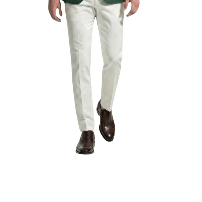 Dark brown leather oxford shoes paired with white trousers front walk
