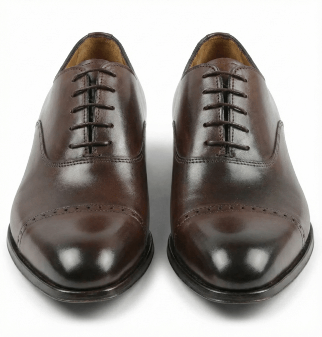 Top view of dark brown leather oxford shoes classic closed lacing