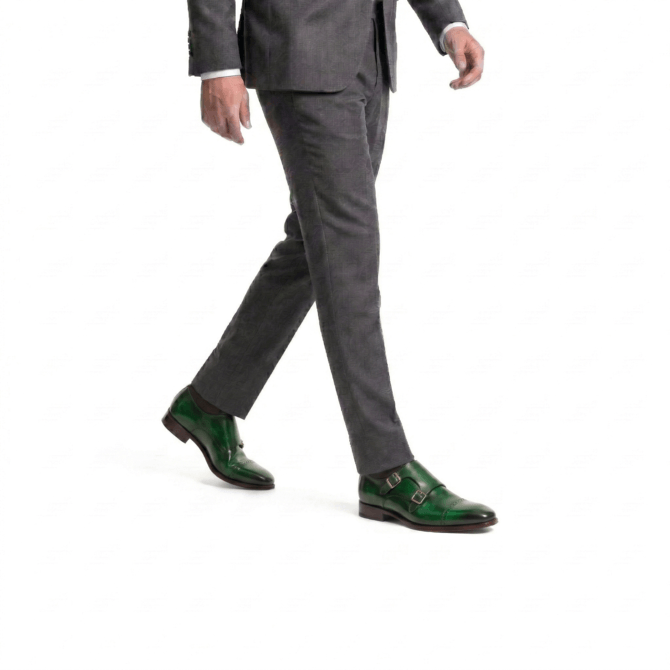 Man walking wearing green monk strap formal shoes left step view