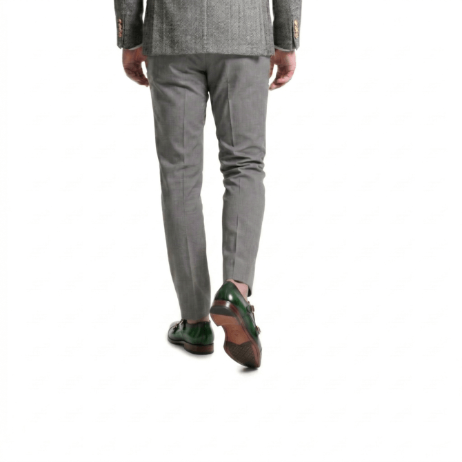 Man wearing green leather monk strap shoes walking right step angle
