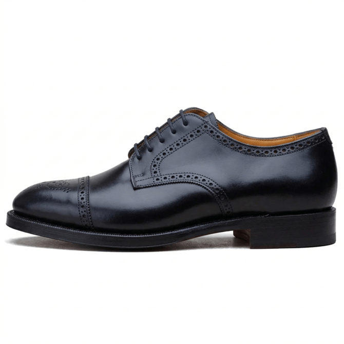 Side perspective of classic men's black leather wingtip oxford shoes with a refined almond toe and premium leather sole.