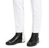 men wearing black leather boots with white pants stylish look