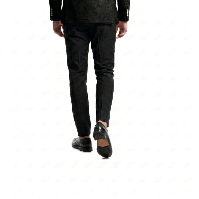 Rear lifestyle shot of men's black leather brogue oxfords with classic leather soles, styled for a formal look.