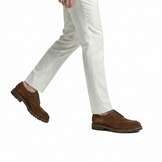 Men styling brown suede derby shoes with white trousers