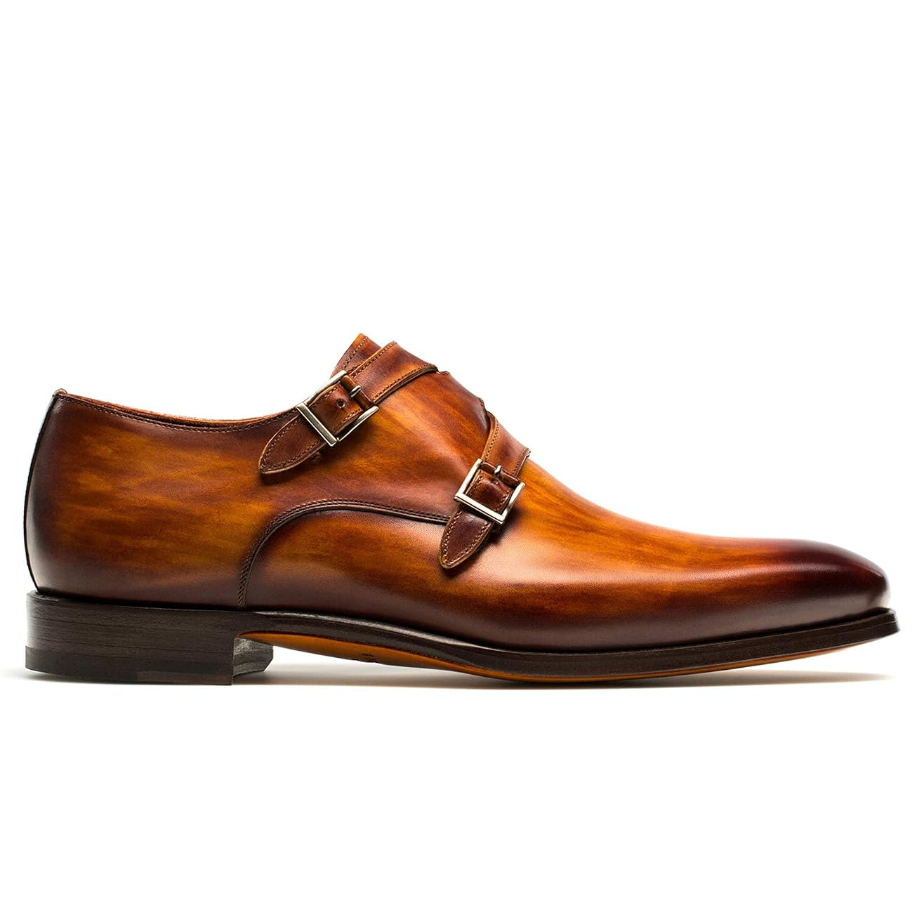 Side perspective of men's handcrafted tan leather double monk strap shoes with a refined almond toe and polished finish.