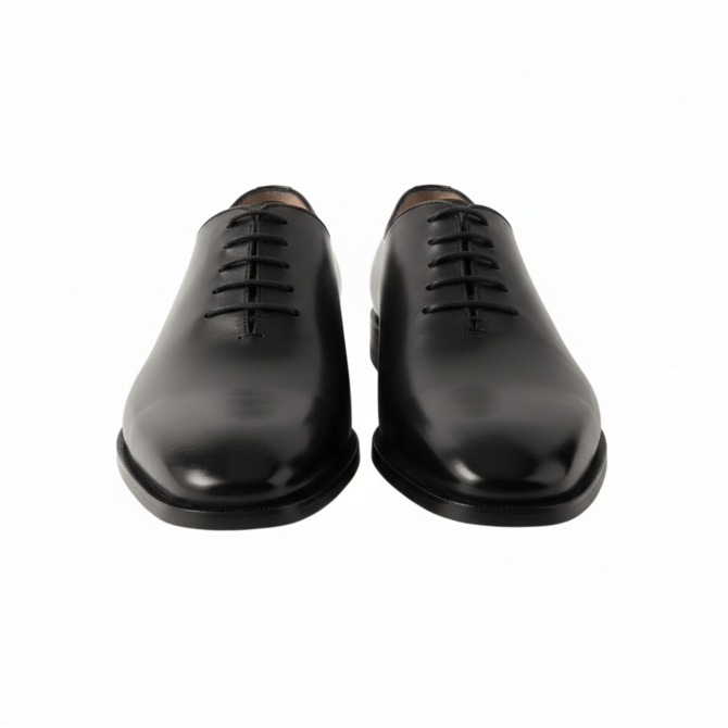 Front-facing view of men's black leather Oxfords highlighting the closed lacing system and almond toe.