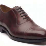 Side angle of polished burgundy brown leather Oxford formal shoe