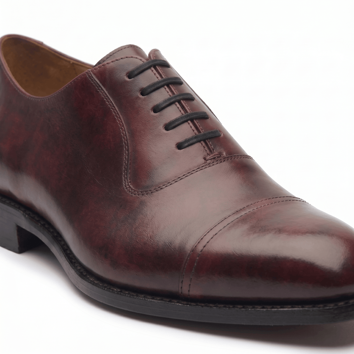 Side angle of polished burgundy brown leather Oxford formal shoe