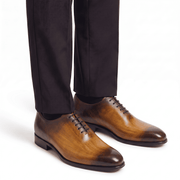 Brown leather lace-up shoes worn with formal trousers
