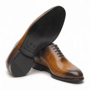 Brown leather dress shoe shown from bottom angle