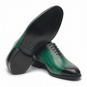Green leather dress shoe shown from bottom angle