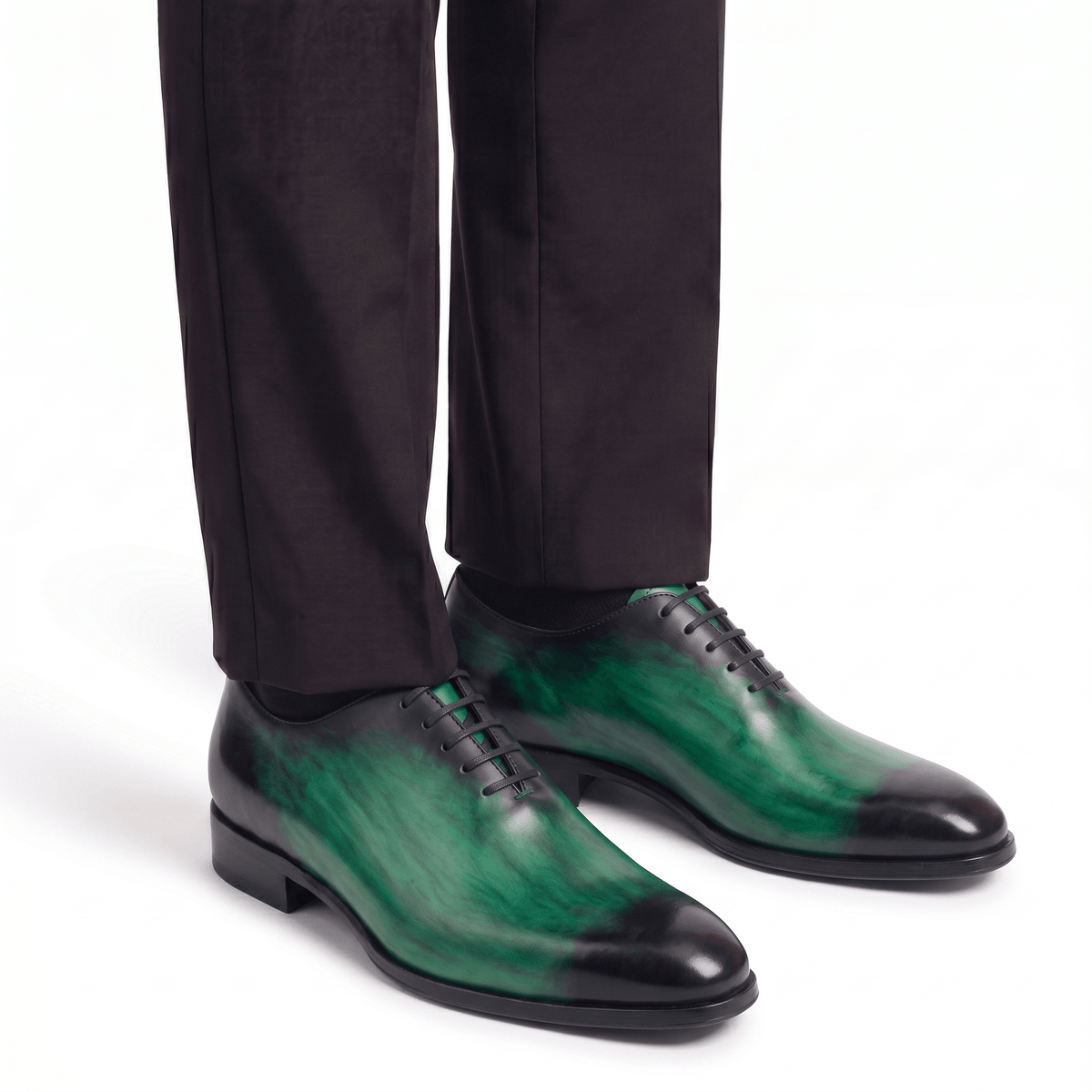 Green leather dress shoes worn with formal trousers
