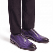 Purple leather dress shoes worn with formal trousers