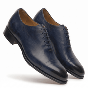 Navy blue leather formal shoes for men, angled side view