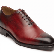 Side view of burgundy leather lace-up dress shoe
