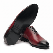 Burgundy leather dress shoe shown from bottom angle