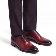 Burgundy leather dress shoes worn with formal trousers