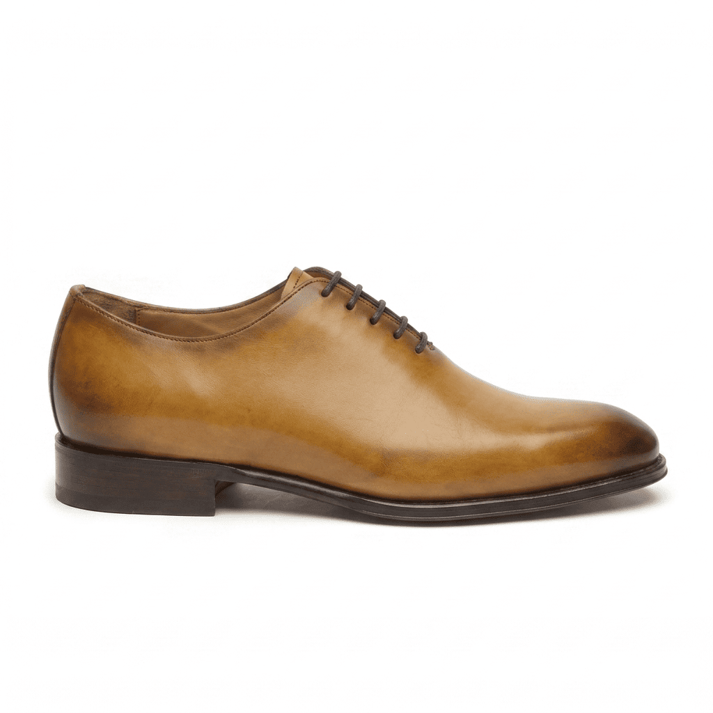 Side profile of tan leather lace-up dress shoe