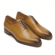 Tan leather lace-up dress shoes with handcrafted finish