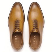 Top view of tan leather lace-up dress shoes