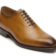 Side view of tan leather lace-up dress shoe