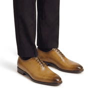 Tan leather dress shoes worn with formal trousers