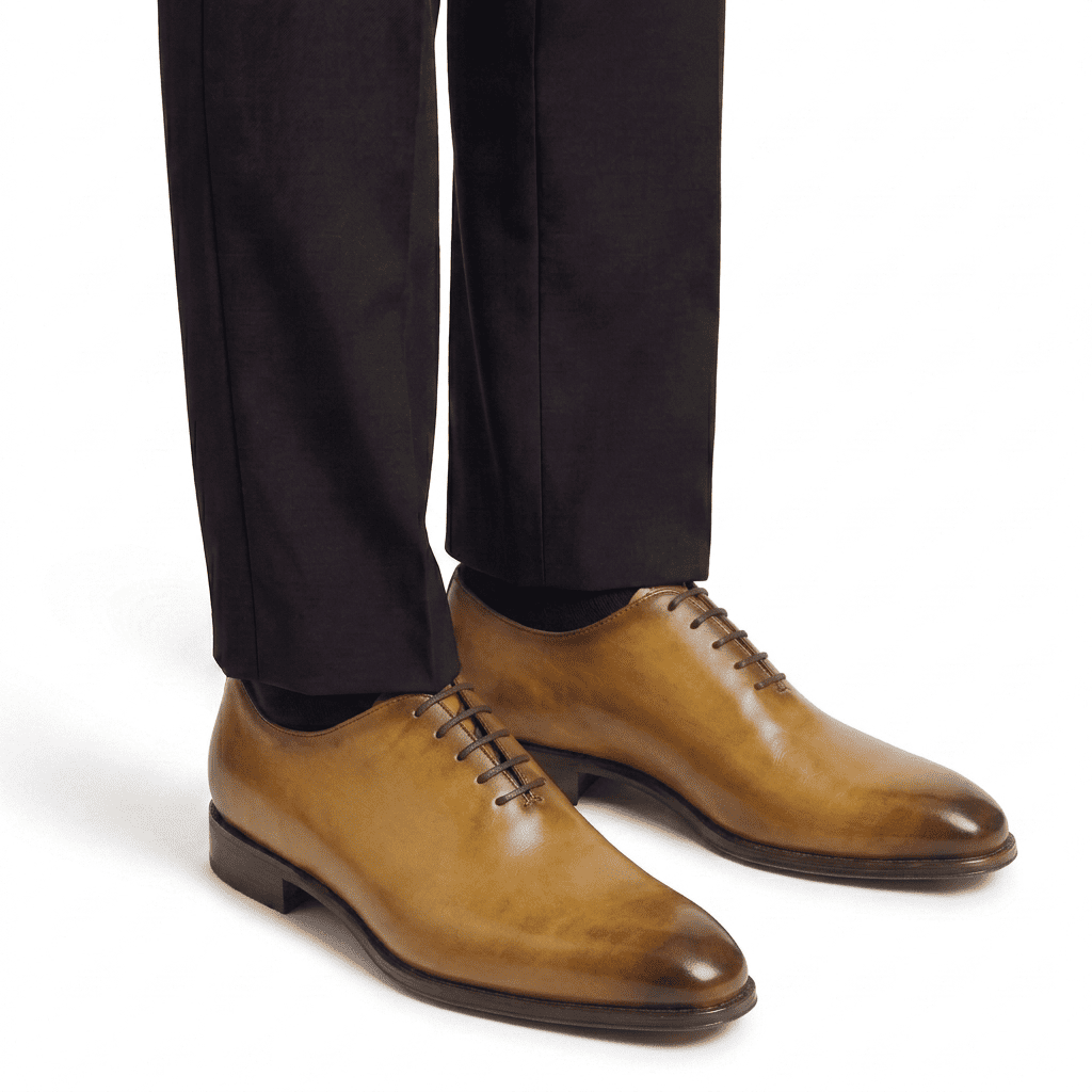 Tan leather dress shoes worn with formal trousers